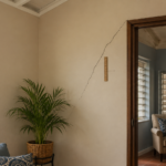 Diagonal wall crack above a doorframe showing a structural warning sign in a Jamaican home